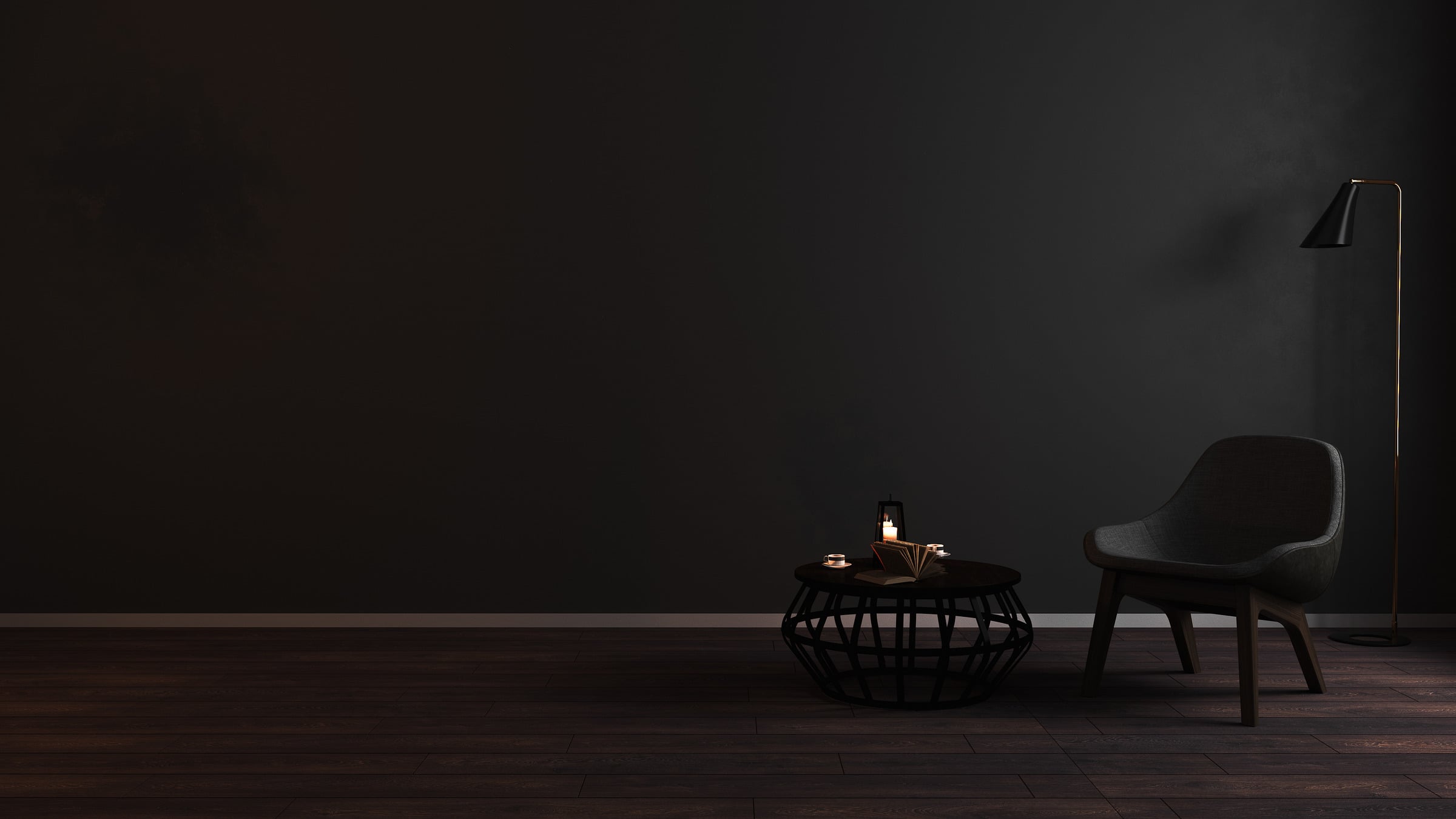 A refined dark interior with an armchair and sculptural table